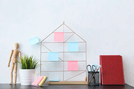 Mood board with different sticky notes, stationery supplies, notebooks, wooden doll and houseplant...