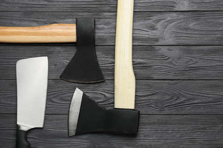 Different sharp axes on dark wooden backgroundの写真素材