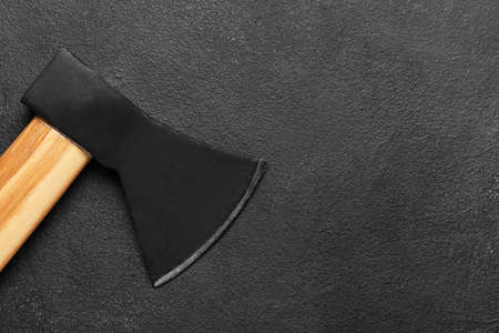Ax with wooden handle on dark background