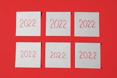 Sticky notes with figure 2022 on red background