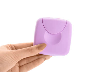Tampons storage box in female hand on white background
