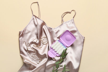 Tampons storage box lying on female silk nightdressの写真素材