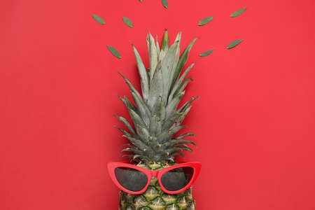 Creative composition with ripe pineapple and sunglasses on color backgroundの写真素材