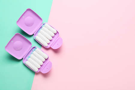 Tampons storage boxes on colorful background, top viewの写真素材