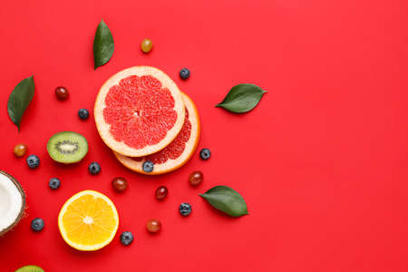 Composition with different fruits and berries on color background