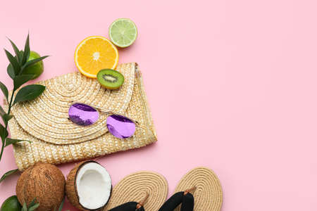 Composition with beach accessories and fruits on color background