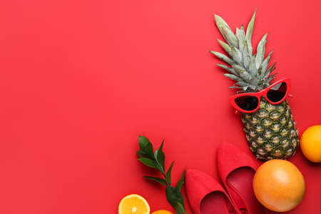 Composition with stylish shoes, sunglasses and fruits on color backgroundの写真素材