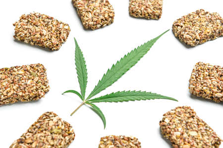 Protein bars with hemp seeds and leaf on white background, closeupの写真素材