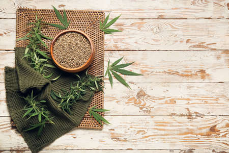 Bowl with hemp seeds on white wooden backgroundの写真素材