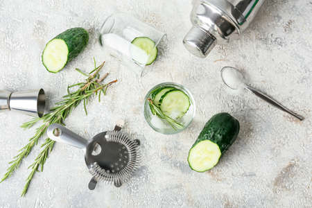 Composition with glass of cold gin tonic and cucumber slices on light backgroundの写真素材