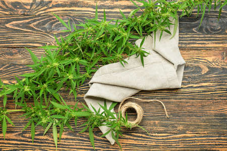 Hemp cloth with threads on wooden backgroundの写真素材