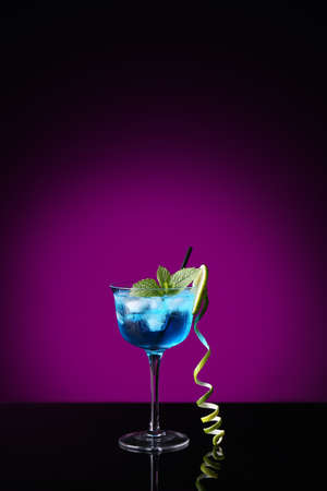Glass of Blue cocktail on dark color backgroundの写真素材