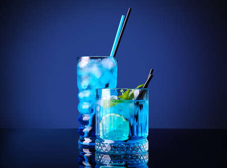 Glasses of Blue cocktail on dark color backgroundの写真素材