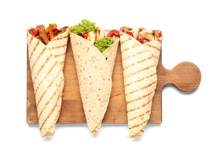 Wooden board with tasty Fajitas on white background