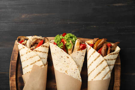 Board with tasty Fajitas on dark wooden background, closeupの写真素材
