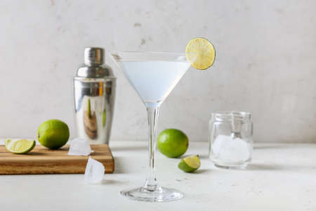 Glass of tasty margarita cocktail on light backgroundの写真素材