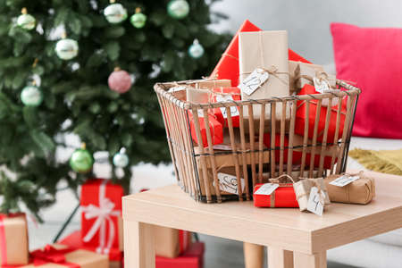 Christmas advent calendar with gift boxes in basket on wooden tableの写真素材