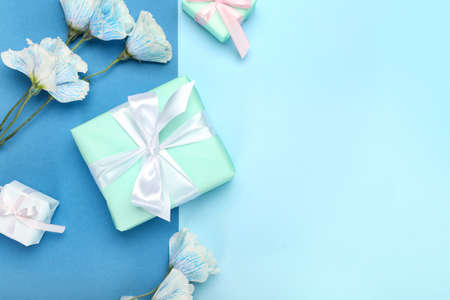 Beautiful gift boxes and flowers on blue backgroundの写真素材