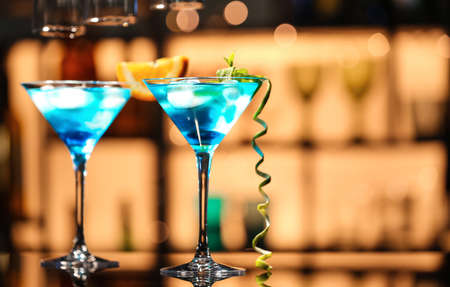 Glasses of Blue cocktail on table in barの写真素材