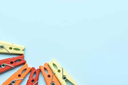 Different clothespins on blue background, closeup