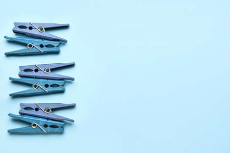 Many plastic clothes pins on blue backgroundの写真素材
