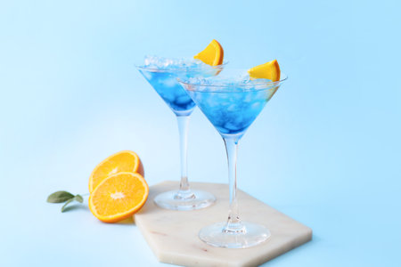 Glasses of Blue Lagoon cocktail on color backgroundの写真素材