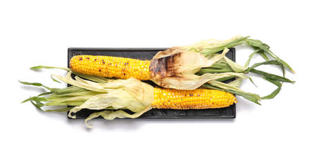 Board with delicious grilled Mexican street corn on white background