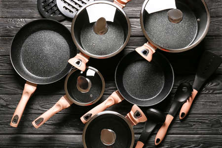 Different kitchen utensils on dark wooden backgroundの写真素材