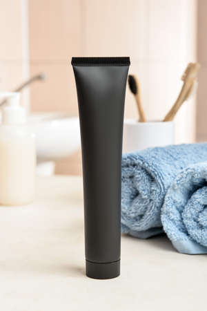 Black toothpaste with activated carbon on table in bathroom