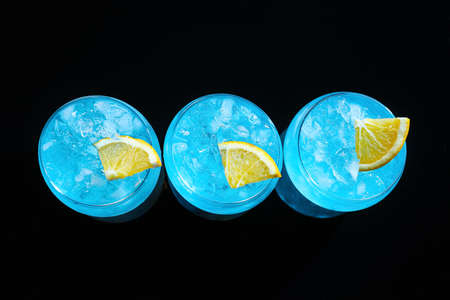 Glasses of Blue Lagoon cocktail on dark backgroundの写真素材