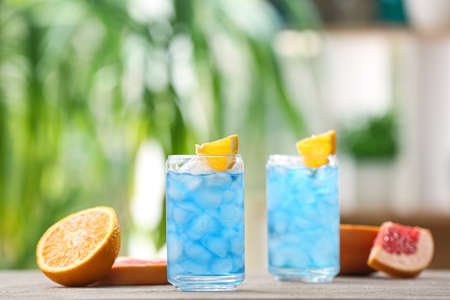 Glasses of Blue Lagoon cocktail on table outdoors, closeupの写真素材