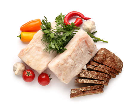 Salted lard with fresh vegetables and bread on white background