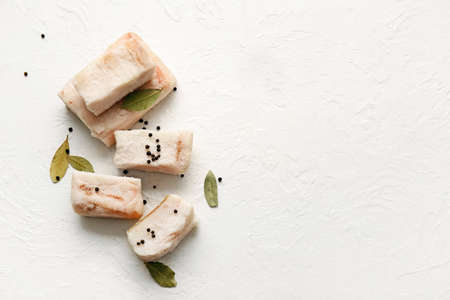 Pieces of salted lard on light background