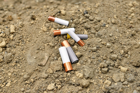 Alkaline batteries on soil outdoorsの写真素材