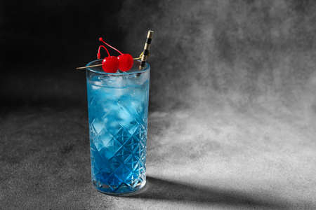 Glass of Blue  cocktail on dark backgroundの写真素材