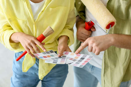 Young couple with palette samples planning design of their new house