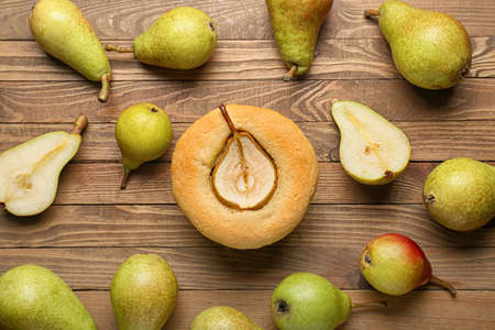 Tasty pear pot pie and fresh fruits on wooden backgroundの写真素材