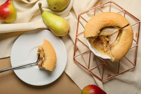 Tasty pear pot pie and fresh fruits on color wooden backgroundの写真素材