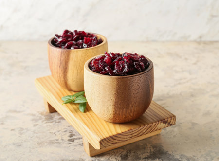 Bowls with tasty dried cranberries on table, closeupの写真素材