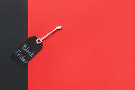 Tag with text BLACK FRIDAY on color background