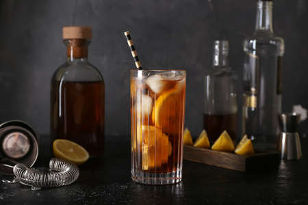 Glass of tasty Long Island iced tea on dark backgroundの写真素材