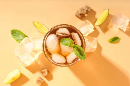 Glass of tasty Long Island iced tea on color backgroundの写真素材