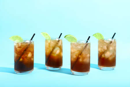 Glasses of tasty Long Island iced tea on color backgroundの写真素材