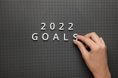 Female hand with text 2022 GOALS on board