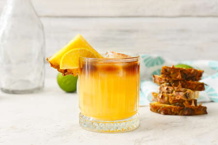Glass of tasty mai tai cocktail on table