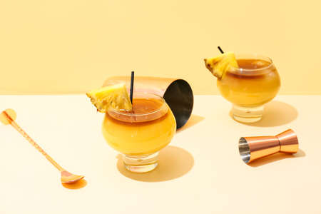 Glasses of tasty mai tai cocktail on color backgroundの写真素材