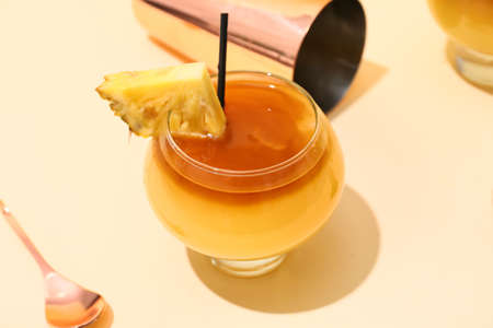 Glass of tasty mai tai cocktail on color background