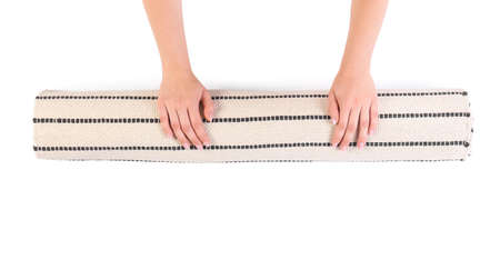 Woman rolling clean carpet on white background