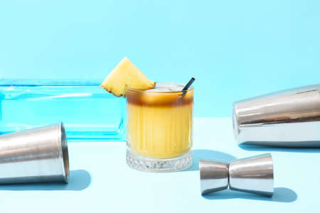 Glass with delicious mai tai cocktail and measure cup on color background