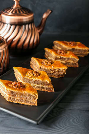 Board with tasty baklava on tableの写真素材